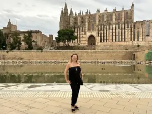 Lada Markman, luxury travel advisor, in front of the cathedral in Palma de Mallorca, Spain
